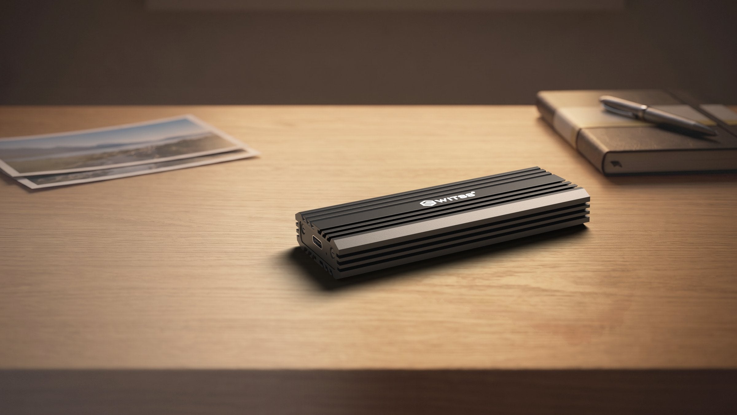 Switss® M.2 SSD enclosure 20 Gbps on a wooden desk, lifestyle shot
