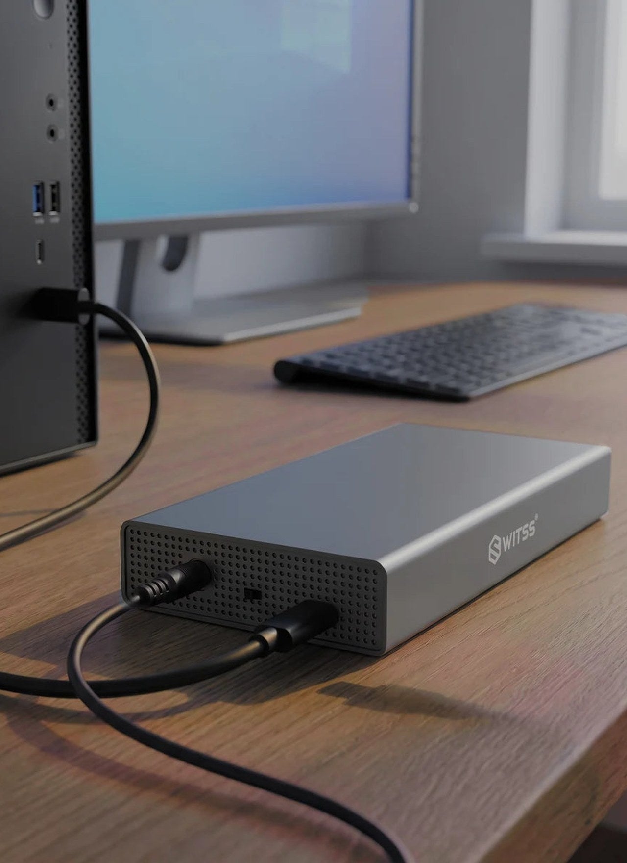 Switss® 3.5 inch HDD enclosure connected to a desktop PC on a wooden desk