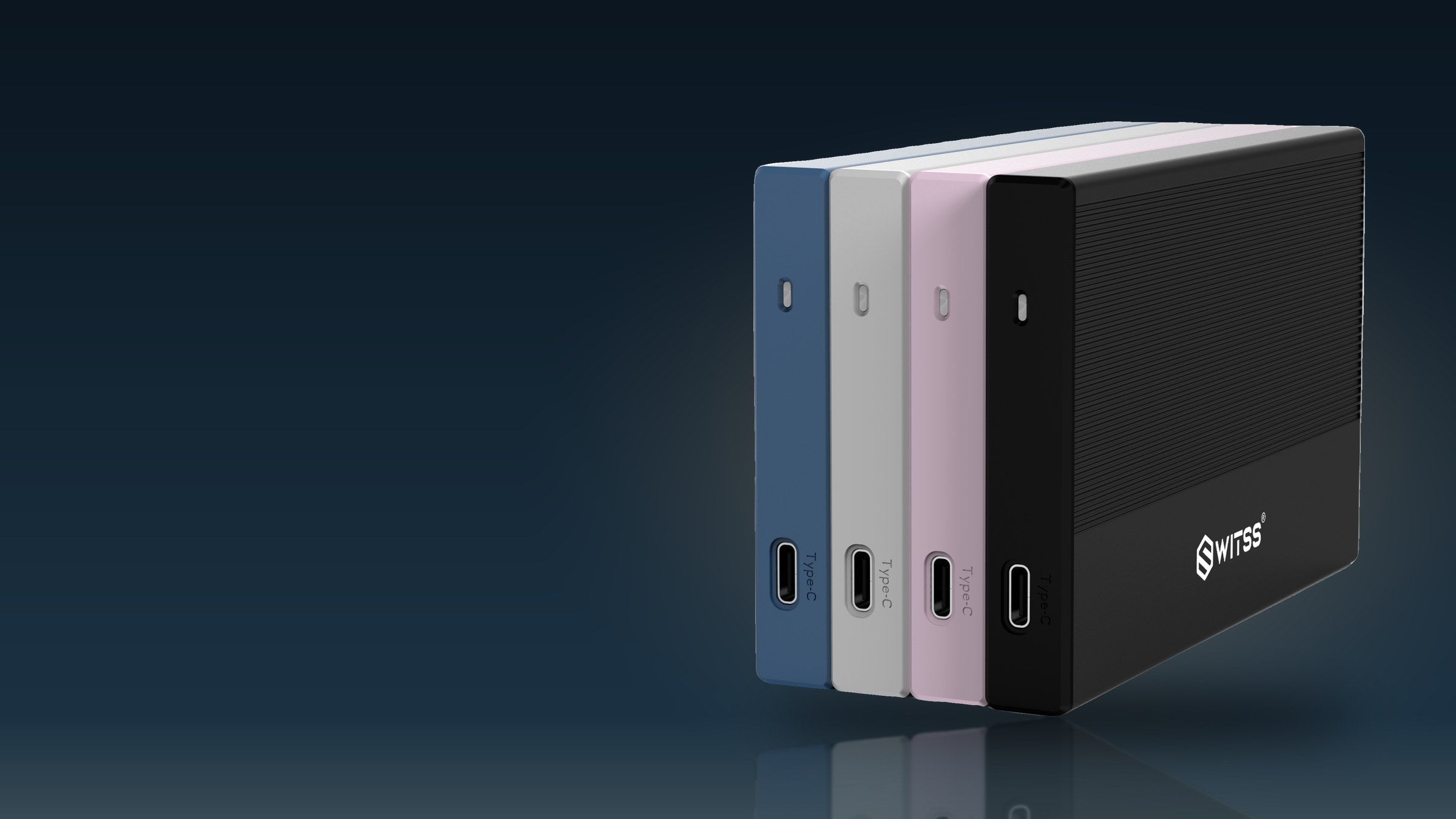 Switss® 2.5 inch enclosure in four colours, upright in a dark studio with warm light
